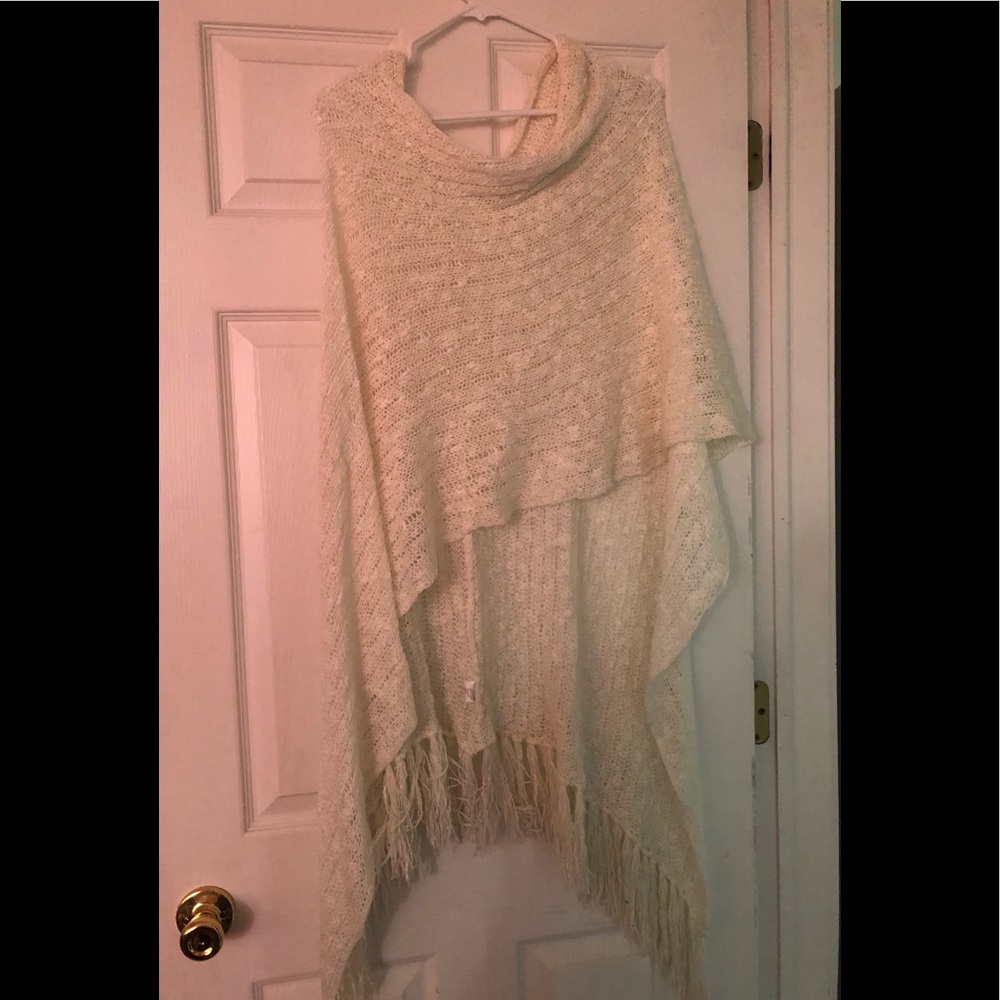 Lovely, light & airy high low cream / off white poncho sweater with fringe.